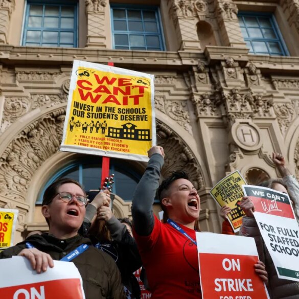 Teachers holding protest signs during a strike in front of Mission High School.