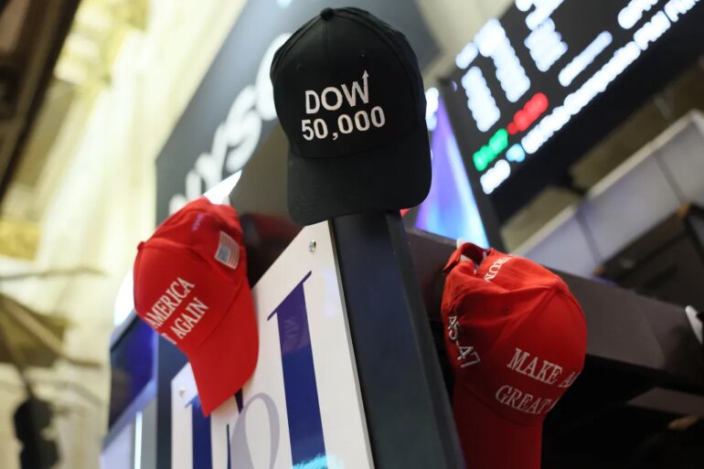 MAGA hats are hung on a wall as traders work on the floor of the New York Stock Exchange during morning trading on February 20th.