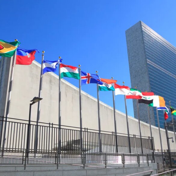 Flags of member states line the entrance to the United Nations Headquarters building.
