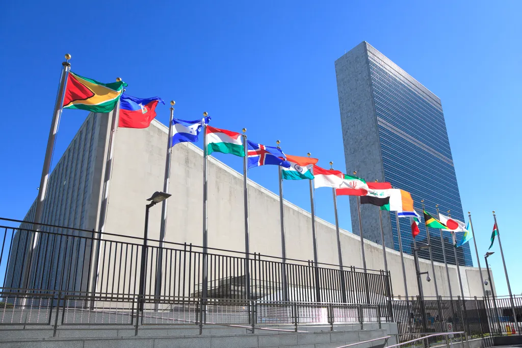 Flags of member states line the entrance to the United Nations Headquarters building.