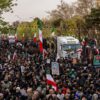TEHRAN, IRAN - JANUARY 14: A crowd watches as the caskets of members of Iran's security forces, whom authorities said were killed during recent nationwide protests, are transported during a mass funeral on January 14, 2026 outside Tehran University in Tehran, Iran. The country has been gripped by a wave of anti-government protests and the ensuing crackdown, which rights groups say has left thousands of civilians dead. (Photo by Stringer/Getty Images)