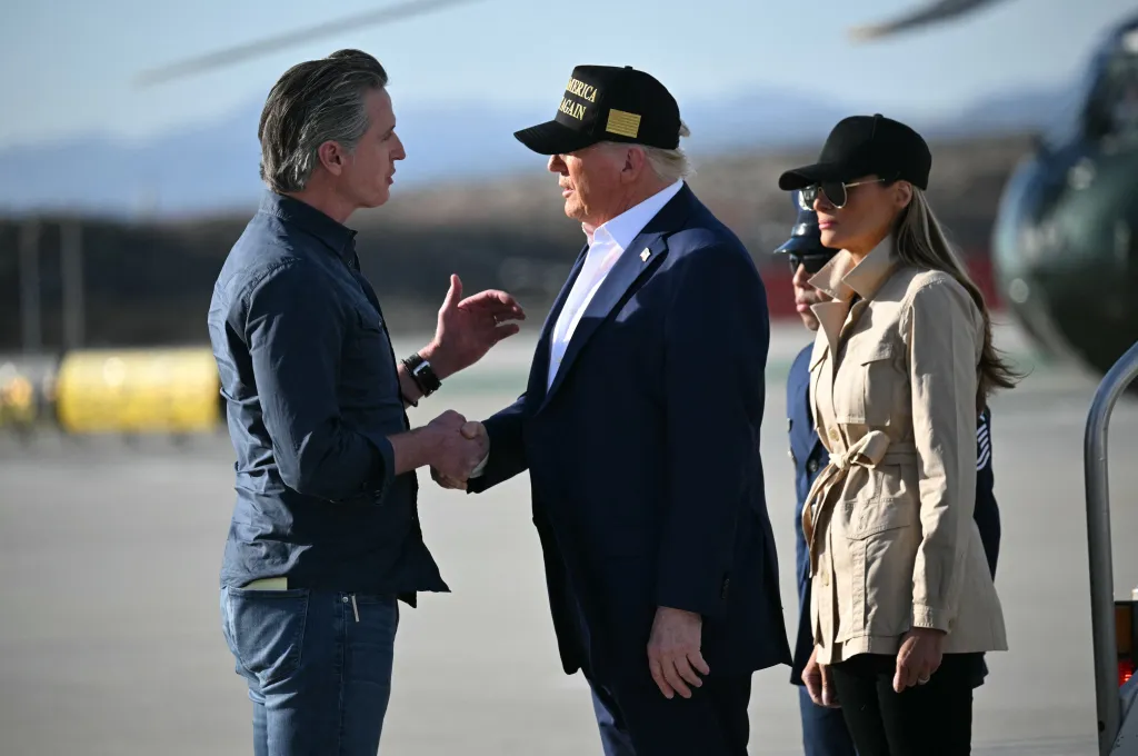 President Trump shakes hands with California Governor Gavin Newsom, with First Lady Melania Trump nearby.
