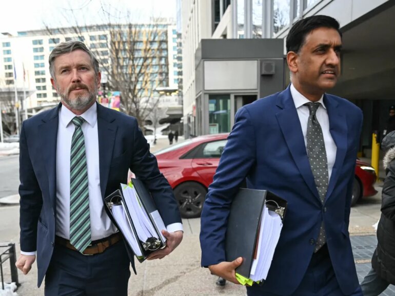 US Representatives Thomas Massie and Ro Khanna arriving at a Department of Justice office.