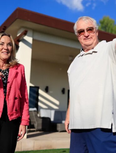 Kathryn Barger and Ted Koerner standing outside Koerner's newly rebuilt home.