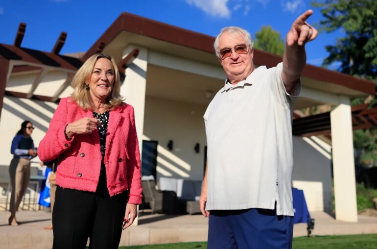 Kathryn Barger and Ted Koerner standing outside Koerner's newly rebuilt home.