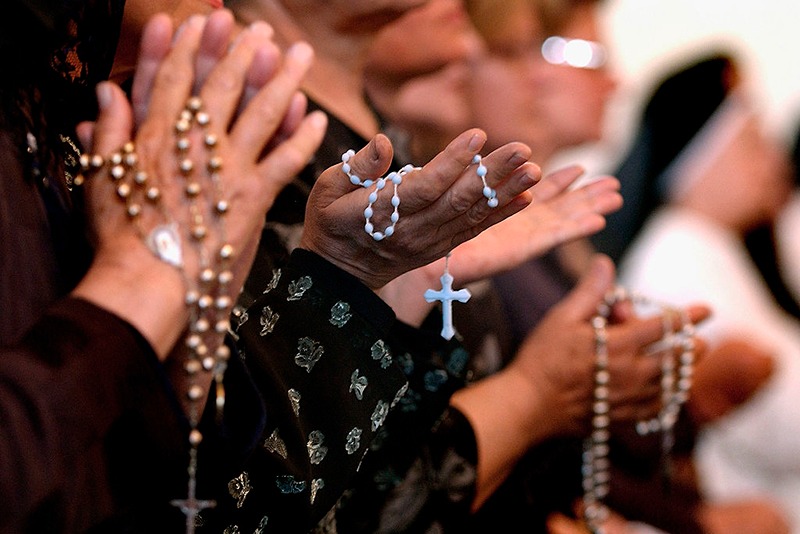 BAGHDAD, IRAQ - APRIL 7: Worshippers pray at a service for Pope John Paul II on April, 7, 2005 at a Catholic church in Baghdad, Iraq. Pope John Paul II died at his residence in the Vatican on April 2, aged 84 years old. His funeral will be held in St. Peter's Square on Friday, April 8. Cardinals under the age of 80 will start the conclave on April 18, where a new Pope will be chosen. (Photo by Wathiq Khuzaie/Getty Images)