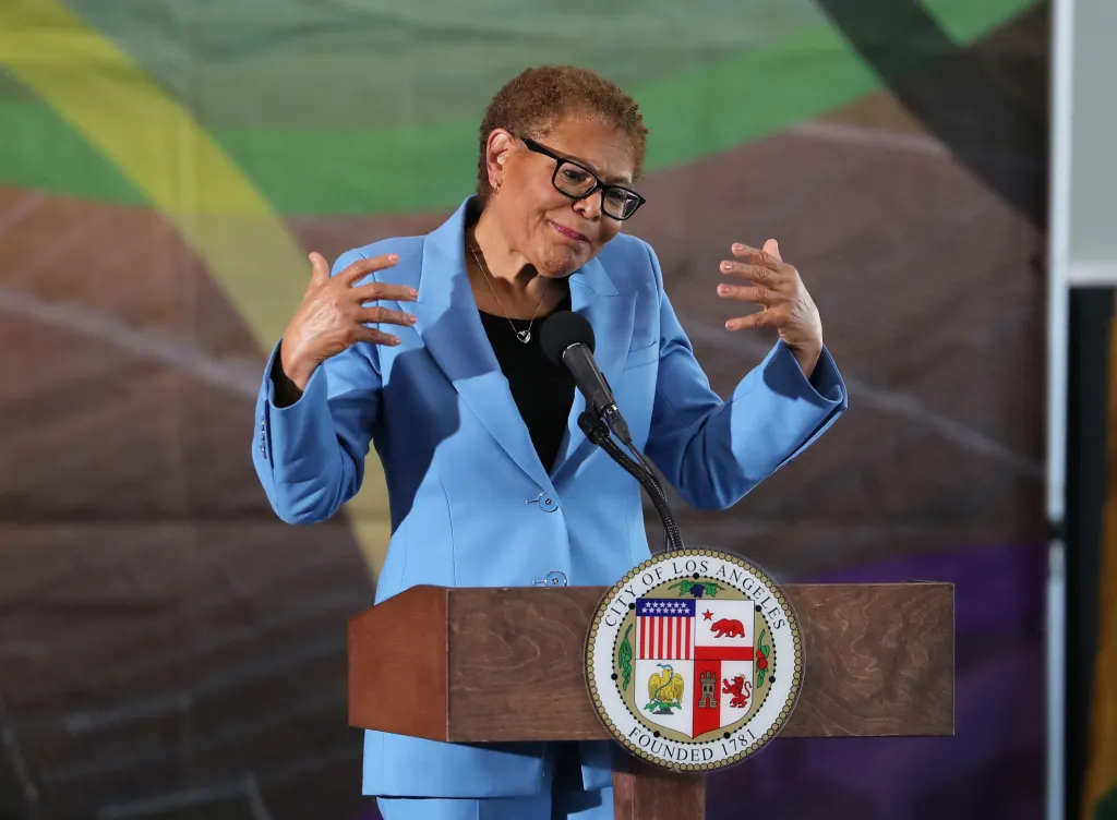 Los Angeles Mayor Karen Bass speaking at a podium with the city's seal.