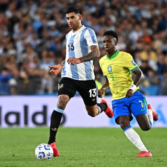 Argentina's Cristian Romero in action with Brazil's Vinicius Junior.