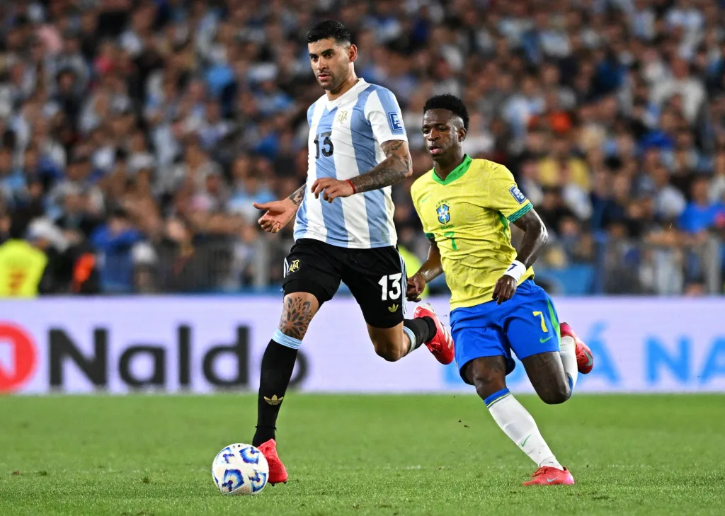 Argentina's Cristian Romero in action with Brazil's Vinicius Junior.