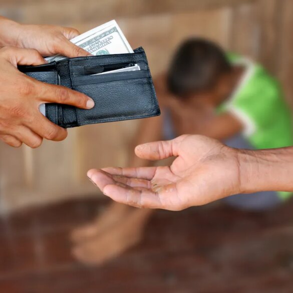 A person's hands holding a wallet full of money over another person's open, dirty hand, with a third, sad, blurred person in the background, illustrating human trafficking.