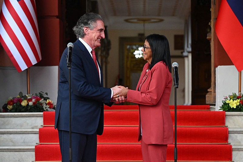 Venezuela's interim president, Delcy Rodriguez, shakes hands with US Interior Secretary Doug Burgum after their meeting at the Miraflores Presidential Palace in Caracas on March 4, 2026. US Interior Secretary Doug Burgum on March 4, 2026, became the latest senior Trump administration official to visit Venezuela, as Washington pushes to ramp up oil and mineral production in the country. (Photo by Federico PARRA / AFP via Getty Images)