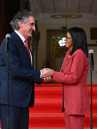 Venezuela's interim president, Delcy Rodriguez, shakes hands with US Interior Secretary Doug Burgum after their meeting at the Miraflores Presidential Palace in Caracas on March 4, 2026. US Interior Secretary Doug Burgum on March 4, 2026, became the latest senior Trump administration official to visit Venezuela, as Washington pushes to ramp up oil and mineral production in the country. (Photo by Federico PARRA / AFP via Getty Images)