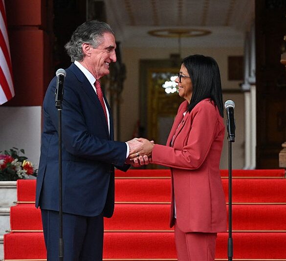 Venezuela's interim president, Delcy Rodriguez, shakes hands with US Interior Secretary Doug Burgum after their meeting at the Miraflores Presidential Palace in Caracas on March 4, 2026. US Interior Secretary Doug Burgum on March 4, 2026, became the latest senior Trump administration official to visit Venezuela, as Washington pushes to ramp up oil and mineral production in the country. (Photo by Federico PARRA / AFP via Getty Images)