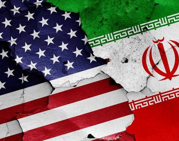 Cracked American and Iranian flags on a wall.