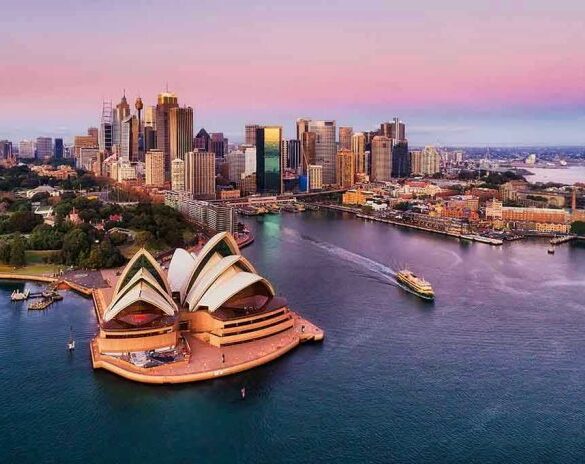 Sydney Opera House and city skyline at sunset.