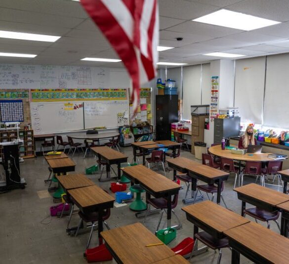 LOUISVILLE, KY - JANUARY 11: A teacher interacts with students virtually while sitting in an empty classroom during a period of Non-Traditional Instruction (NTI) at Hazelwood Elementary School on January 11, 2022 in Louisville, Kentucky. Jefferson County Public Schools, along with many other school districts in the US, have switched to NTI in response to severe staffing shortages caused by the prevalence of the omicron variant of COVID-19. (Photo by Jon Cherry/Getty Images)