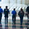 Transportation Security Administration (TSA) agents walk through Ronald Reagan National Airport in Arlington, Virginia, on March 9, 2026. (Photo by Aaron Schwartz / AFP via Getty Images)
