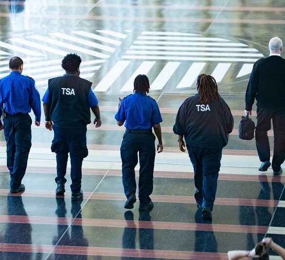 Transportation Security Administration (TSA) agents walk through Ronald Reagan National Airport in Arlington, Virginia, on March 9, 2026. (Photo by Aaron Schwartz / AFP via Getty Images)