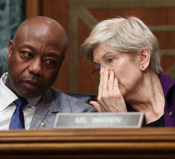 WASHINGTON, DC - FEBRUARY 05: Chair of the Senate Committee on Banking, Housing, and Urban Affairs Sen. Tim Scott (R-SC) talks to Ranking Member Sen. Elizabeth Warren (D-MA) as U.S. Treasury Secretary Scott Bessent testifies before the committee in the Dirksen Senate Office Building on February 05, 2026 in Washington, DC. The Committee met to hear testimony on the Financial Stability Oversight Council’s Annual Report to Congress. (Photo by Kevin Dietsch/Getty Images)