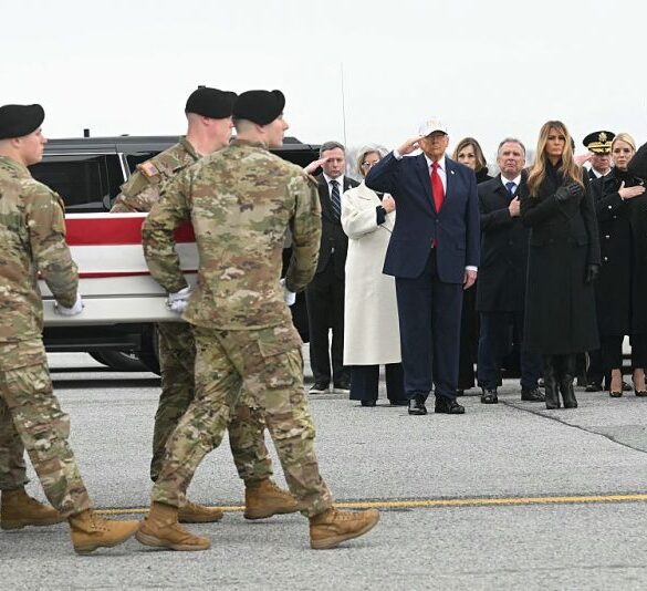 (L/R) White House chief of staff Susie Wiles, US President Donald Trump, special envoy Steve Witkoff, First Lady Melania Trump and Attorney General Pam Bondi lookon as members of a US Army team carry a flagged-drapped transfer case containing the remains of one of six US soldiers during a dignified transfer solemn event at Dover Air Force Base, in Dover, Delaware, on March 7, 2026. Six US Army soldiers were killed March 1 when an Iranian drone struck a key US command center in Kuwait's southern industrial hub of Port Shuaiba, a day after the United States and Israel launched a sweeping military campaign against Iran. (Photo by SAUL LOEB / AFP via Getty Images)