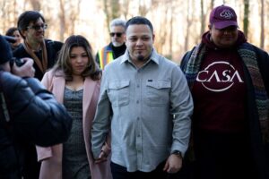GREENBELT, MARYLAND - DECEMBER 22: Kilmar Abrego Garcia arrives with his wife Jennifer Vasquez Sura and his attorney Simon Sandoval-Moshenberg (L) at U.S. District Court for the District of Maryland on December 22, 2025 in Greenbelt, Maryland. Abrego Garcia, a longtime Maryland resident who was deported to the high-security CECOT prison in El Salvador, then sent back to the U.S. and released after the court found his detention unlawful, attended a hearing on whether Immigration and Customs Enforcement (ICE) may re-detain him. (Photo by Alex Wong/Getty Images)