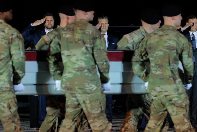 DOVER, DELAWARE - MARCH 09: U.S. Vice President JD Vance and U.S. Secretary of War Pete Hegseth, salutes as a U.S. Army carry team moves a flag-draped transfer case containing the remains of Army Sgt. Benjamin N. Pennington at Dover Air Force Base on March 9, 2026 in Dover, Delaware. Pennington died of injuries sustained from an Iranian attack on Prince Sultan Air Base in Saudi Arabia on March 1. (Photo by Chip Somodevilla/Getty Images)