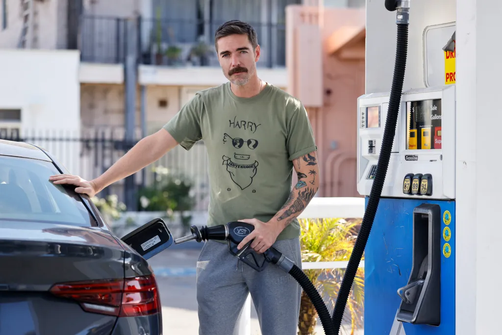 Greg Maness fills his car with gas at a SoCal Gas station on Vermont Ave.