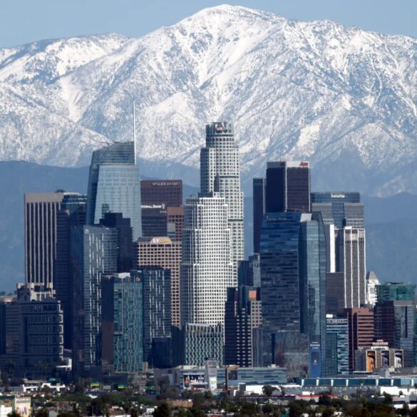 Snow-covered mountains loom over Los Angeles.