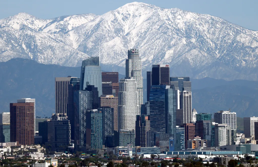 Snow-covered mountains loom over Los Angeles.