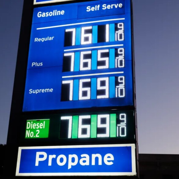 Gas prices displayed on a sign for Regular, Plus, Supreme, and Diesel No. 2 all showing $7.69 and 9/10, with a separate sign for Propane below.