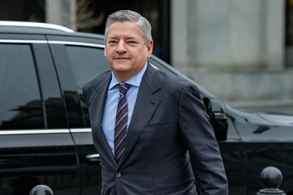 Ted Sarandos, Netflix CEO, wearing a suit and tie, arriving at the White House.