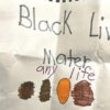 Illustration of a child's drawing with "Black Lives Mater any life" written in marker and three brown/orange colored ovals.