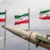 TEHRAN, IRAN - FEBRUARY 11: Missiles produced by Iran's armed forces are displayed near a row of Iranian flags during commemorations to mark the anniversary of the 1979 Iranian Revolution on February 11, 2026 in Tehran, Iran. In that year, Ruhollah Khomeini led an overthrow of the Pahlavi dynasty in 1979 and established himself as Supreme Leader of the Islamic Republic of Iran. (Photo by Majid Saeedi/Getty Images)