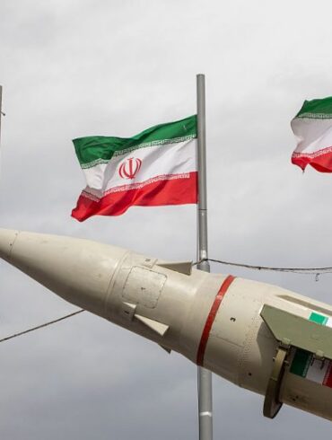 TEHRAN, IRAN - FEBRUARY 11: Missiles produced by Iran's armed forces are displayed near a row of Iranian flags during commemorations to mark the anniversary of the 1979 Iranian Revolution on February 11, 2026 in Tehran, Iran. In that year, Ruhollah Khomeini led an overthrow of the Pahlavi dynasty in 1979 and established himself as Supreme Leader of the Islamic Republic of Iran. (Photo by Majid Saeedi/Getty Images)