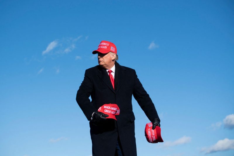 TOPSHOT - US President Donald Trump throws hats to supporters during a Make America Great Again rally at Wilkes-Barre Scranton International Airport November 2, 2020, in Avoca, Pennsylvania. The US presidential campaign enters its final day Monday with a last-minute scramble for votes by Donald Trump and Joe Biden, drawing to a close an extraordinary race that has put a pandemic-stricken country on edge. (Photo by Brendan Smialowski / AFP) (Photo by BRENDAN SMIALOWSKI/AFP via Getty Images)