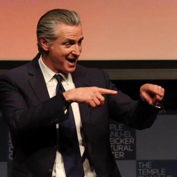 California Governor Gavin Newsom speaking and gesturing with both hands.