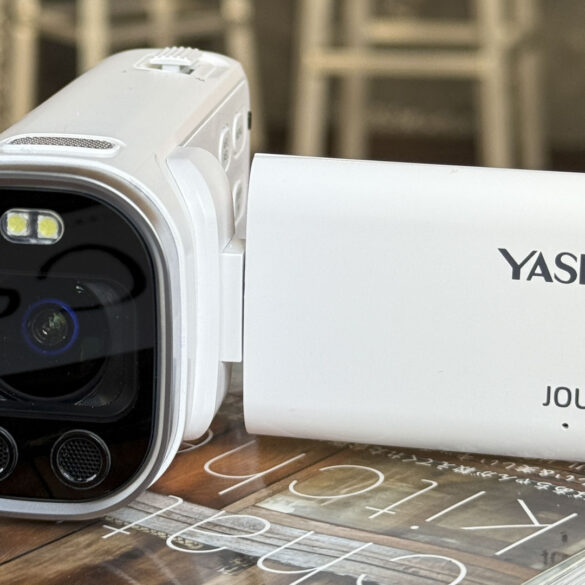 Yashica Journey 4K camcorder in white, rested on a surface with screen flipped out