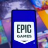Illustration of the Epic Games logo displayed on a smartphone.
